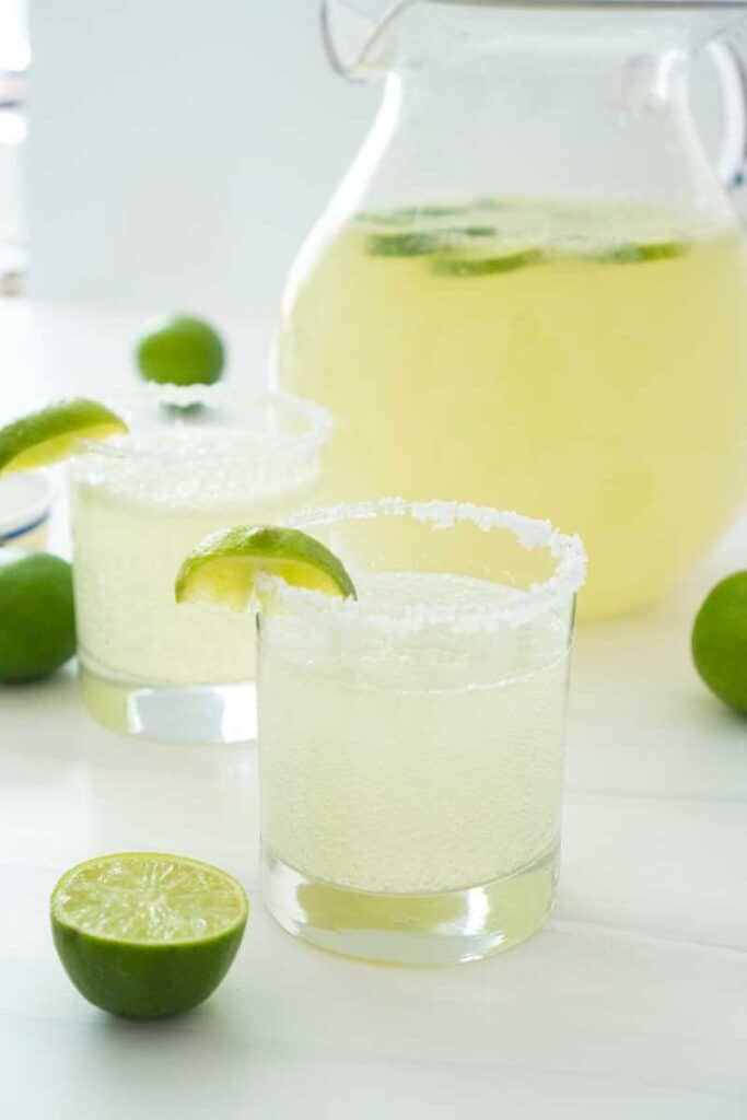 margarita punch in salt lined glass with lime wedge