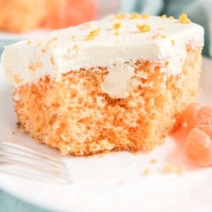 orange creamsicle poke cake on white plate