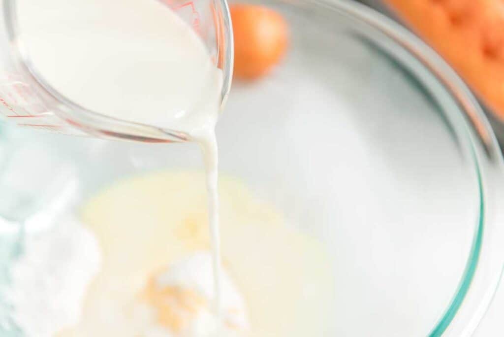 pouring milk in glass bowl