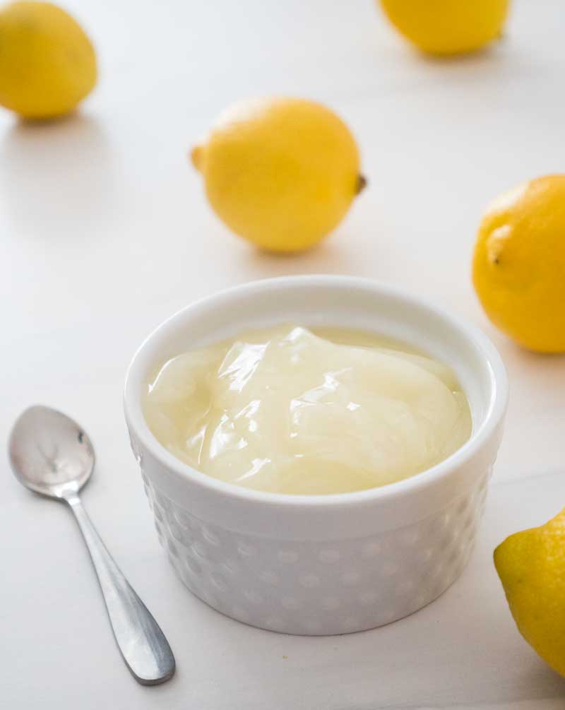 eggless lemon curd in white ramekin with lemons