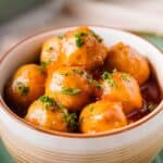 close up of apple jelly meatballs in bowl