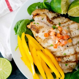 lime butter grilled grouper with yellow sliced bell pepper and pico de gallo