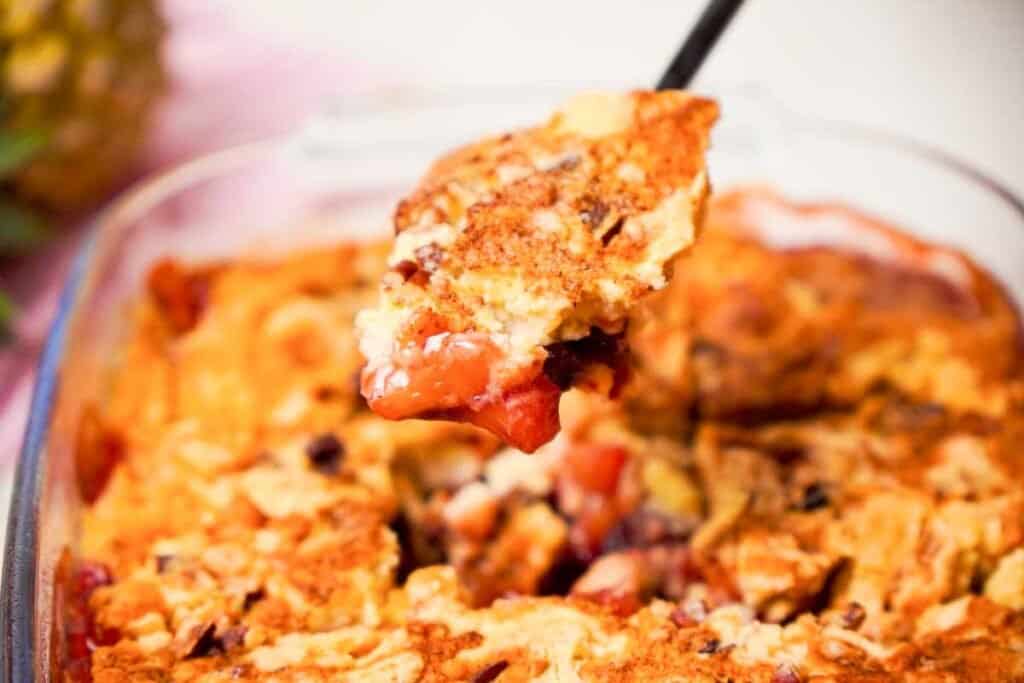 serving spoon with cherry pineapple dump cake