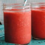 red slushy punch in a mason jar with straw