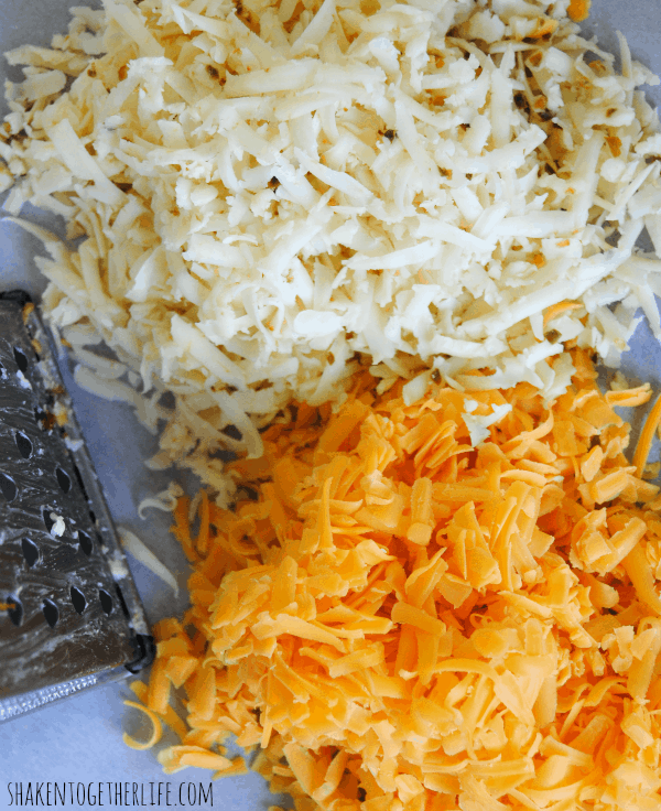 Piles of sharp cheddar and pepperjack cheeses just waiting to become homemade pepperjack pimento cheese!