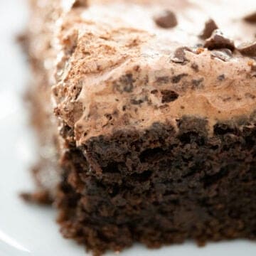 close up of slice of triple chocolate poke cake
