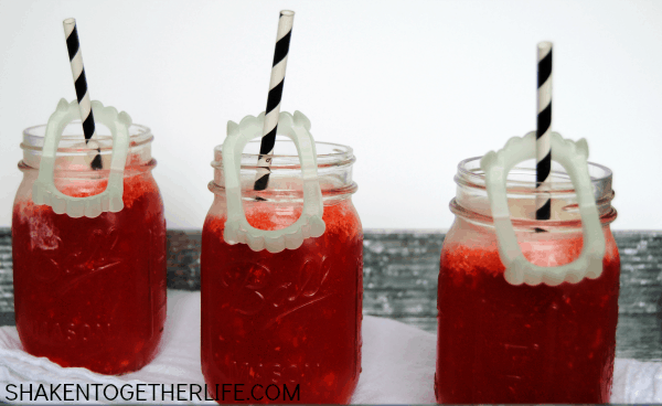 3 Vampire ice cream Floats with black and white straws and fake vampire teeth