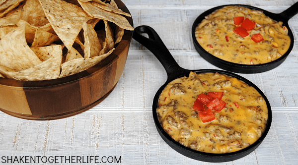 Don't let another day go by without making this awesome crock pot queso dip with beef & sausage! It is our go-to appetizer for game day, parties & potlucks!