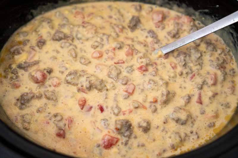 slow cooker with velveeta spicy cheese dip with sausage and ground beef