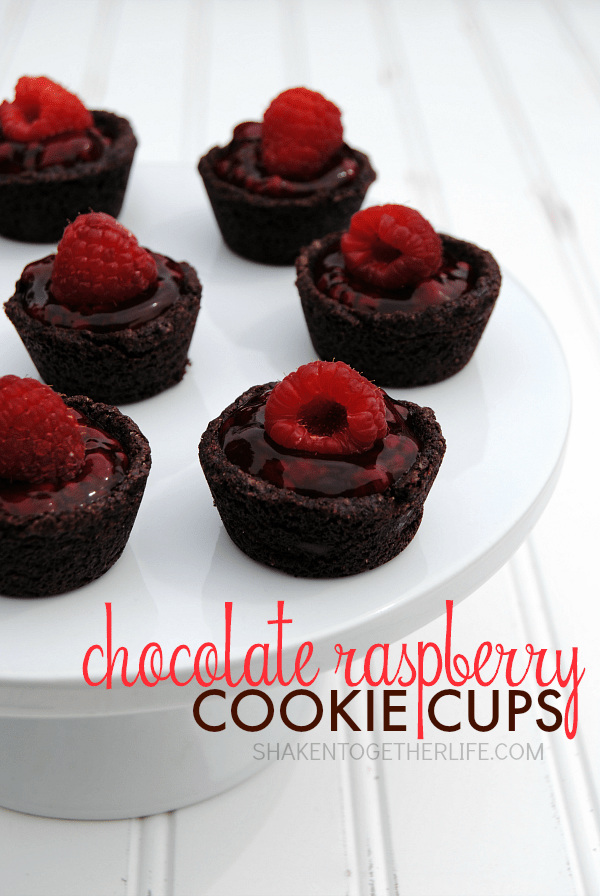 Chocolate Raspberry Cookie Cups - 2 bite triple chocolate cookie cups filled with a sweet raspberry filling and topped with a fresh raspberry - YUM!