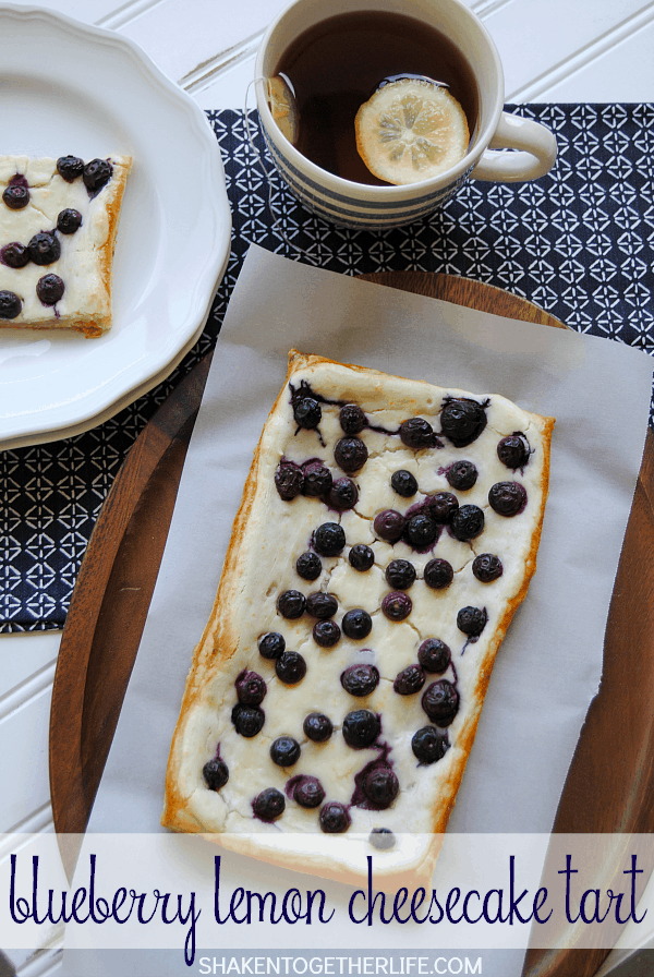 This Blueberry Lemon Cheesecake Tart is SO delicious! Golden flaky puff pastry is topped with a lemon cheesecake filling and fresh blueberries!