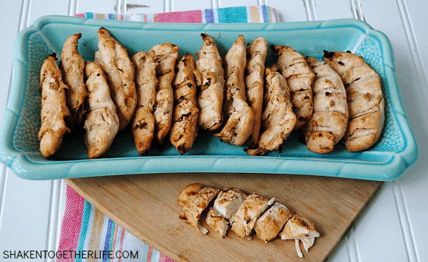 grilled chicken tenderloins on blue platter