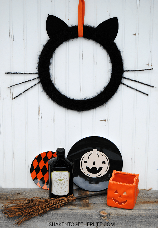 Give your front door or mantel a touch of frightfully furry fun with this easy Black Cat Wreath!