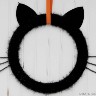 Give your front door or mantel a touch of frightfully furry fun with this easy Black Cat Wreath!