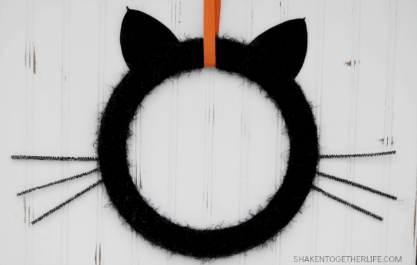 Give your front door or mantel a touch of frightfully furry fun with this easy Black Cat Wreath!