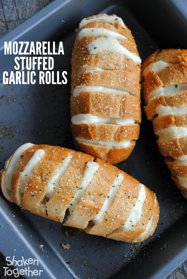 Mozzarella Stuffed Garlic Rolls are a quick and easy side dish! Our family loved to pull apart these ooey gooey cheesy rolls!