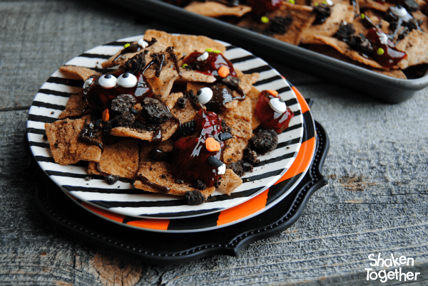 Looking for an easy dessert for Halloween or The Walking Dead party?! Make these sweet, no bake Zombie Nachos! These dessert nachos are layered with all sorts of sweet treats and are dreadfully delicious!