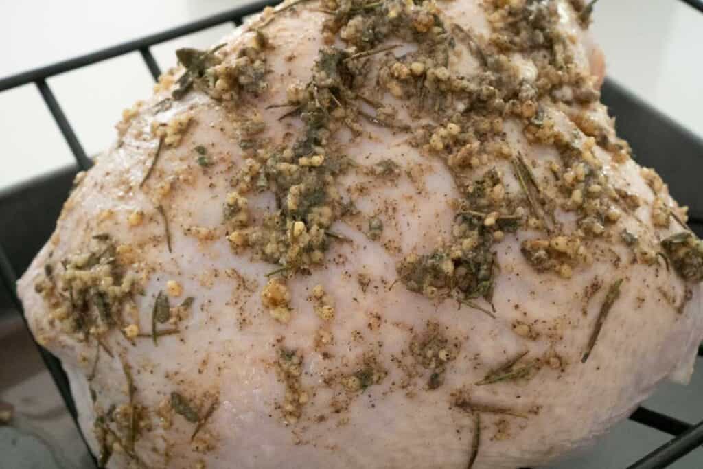 raw turkey breast with seasoning on it