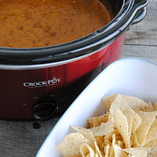 Crock Pot Chili Cheese Dip - so creamy and delicious poured over nachos, hot dogs, fries or baked potatoes!