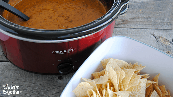 Crock Pot Chili Cheese Dip - so creamy and delicious poured over nachos, hot dogs, fries or baked potatoes!