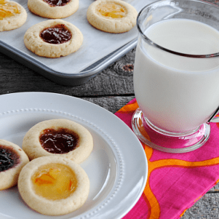 Soft buttery sugar cookies filled with your favorite fruity jam - these might be the easiest Jam Thumbprint Cookies ever!