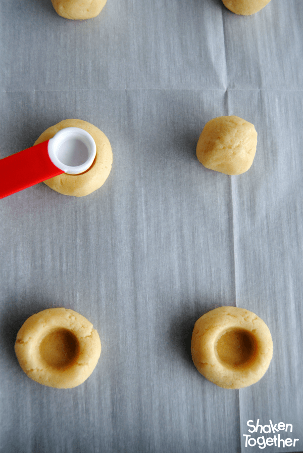 A measuring spoon makes the perfect wells in the dough for our easy Jam Thumbprint Cookies!