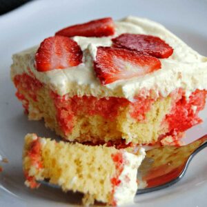 lemon strawberry poke cake with bite on fork