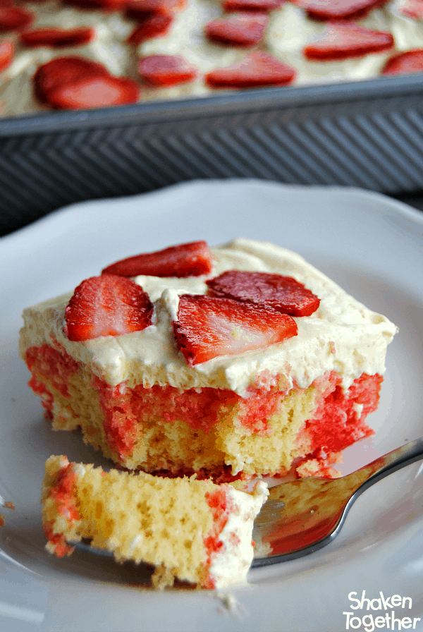 slice of Lemon Strawberry Poke Cake on white plate