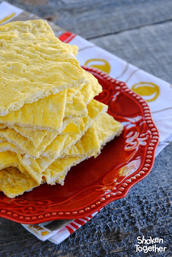 Sheet Pan Eggs cut into squares and stacked on a red plate