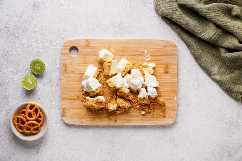 chopped up key lime pie slices on cutting board