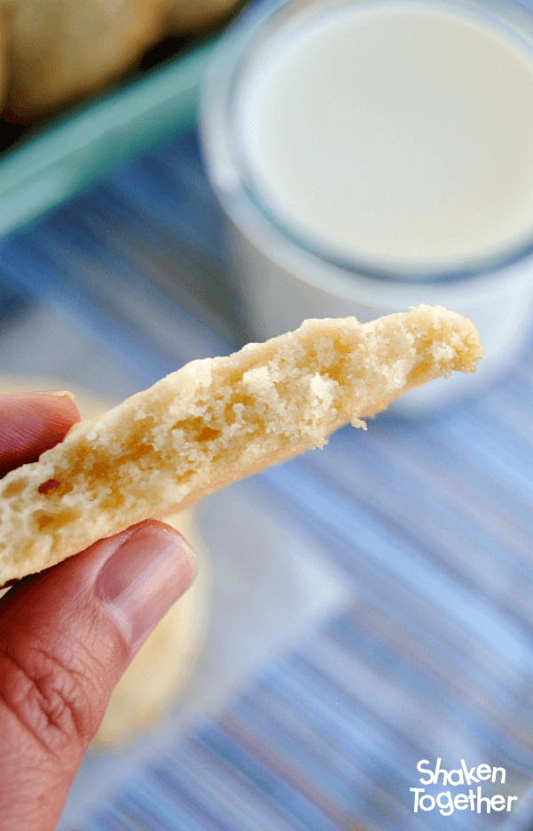 hand holding Lemon Coconut Sugar Cookies broken in half