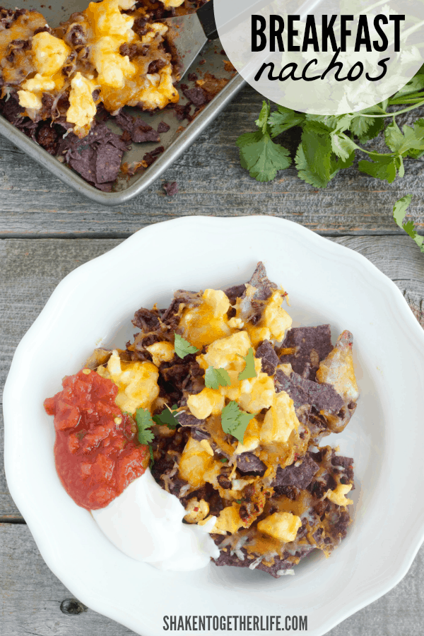 Breakfast Nachos are the perfect way to start Cinco de Mayo! Blue corn tortilla chips are topped with scrambled eggs, chorizo and tons of ooey gooey cheese - we love to finish them off with salsa and Mexican creama!