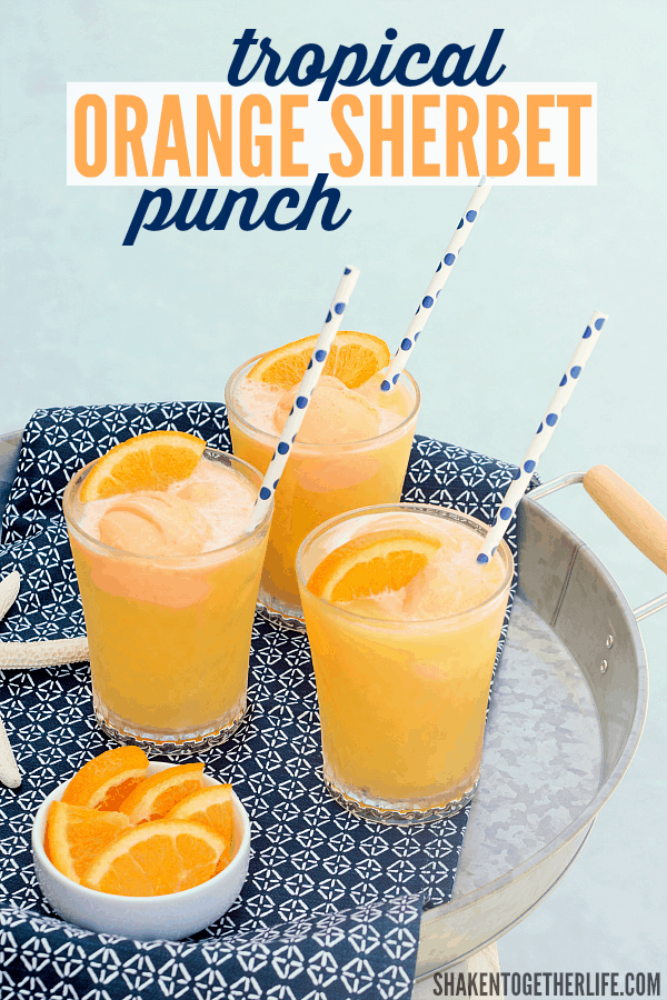 Tropical Orange Sherbet Punch is on repeat this Summer! Tropical fruit juices, lemon lime soda and scoops of orange sherbet make this punch a family favorite!