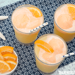Tropical fruit juices, lemon lime soda and orange sherbet make this Tropical Orange Sherbet Punch the perfect Summertime drink!