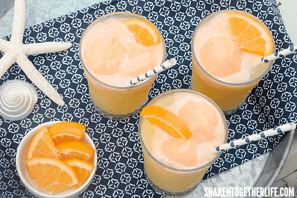 Tropical fruit juices, lemon lime soda and orange sherbet make this Tropical Orange Sherbet Punch the perfect Summertime drink!