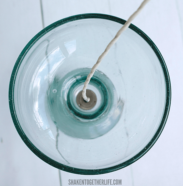 Easy DIY Margarita Scented Candles - step 1 - hot glue the wick to the center of the bottom of the glass