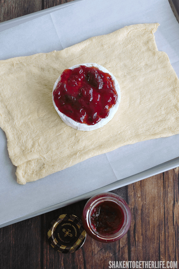 crescent roll dough with brie and jam on top