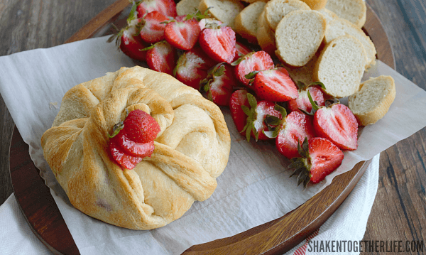 Strawberry Jalapeño Baked Brie is a little appetizer with a BIG flavor! Try spreading a halved strawberry with the melty cheese - YUM!