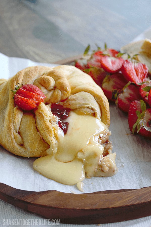 Strawberry Baked Brie with piece removed and cheese oozing out