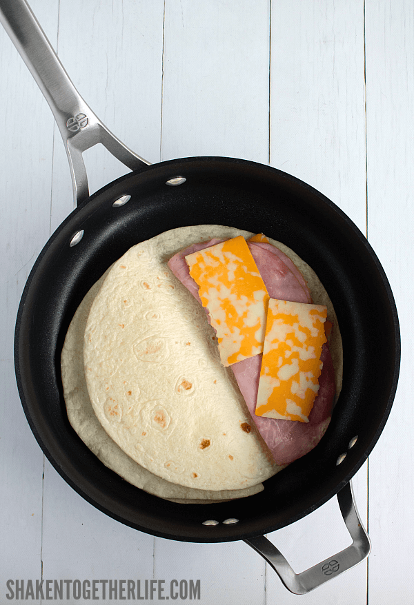 Layer ham & colby cheese on a flour tortillas for these Lunch Box Quesadillas.