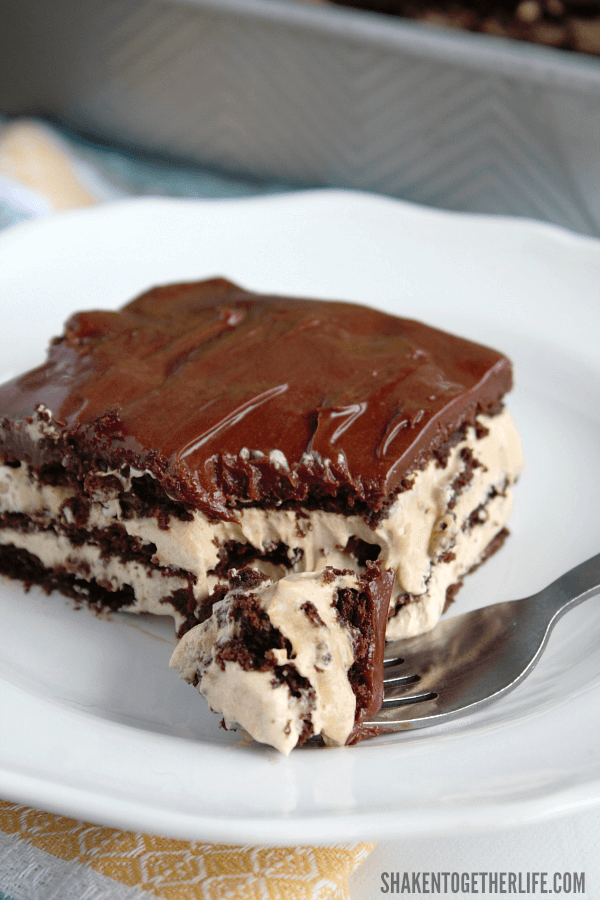 Fluffy iced mocha filling is layered with chocolate graham crackers and fudgy frosting in this easy, amazingly delicious Iced Mocha Eclair Cake!