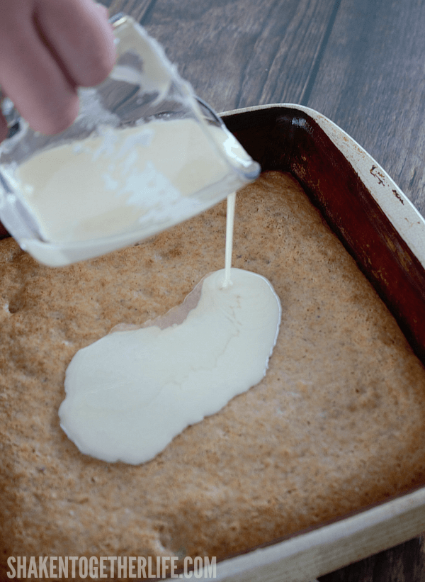 Pour cream cheese frosting over the top of this 3 Ingredient Banana Nut Muffin Cake for the finishing touch!