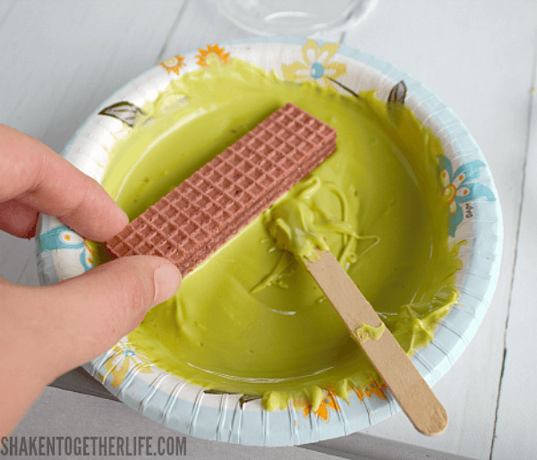 Sugar Wafer Frankenstein Cookies - the first step is to dip each cookie