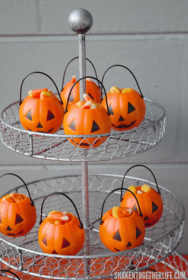 Candy corn filled mini jack-o-lanterns on tiered stand