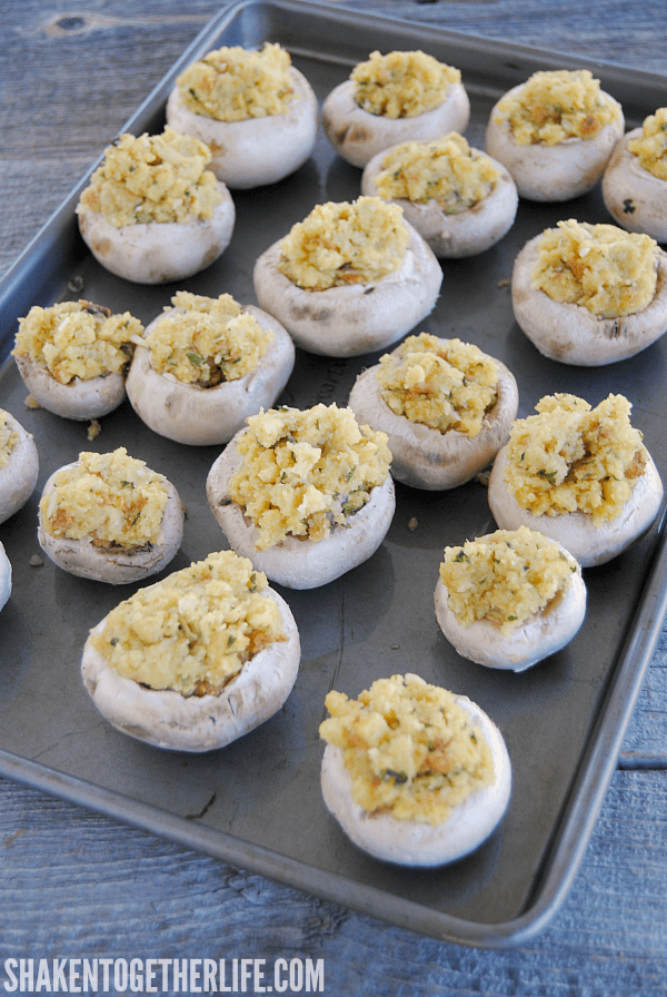 Fill baby portabella mushroom caps with prepared stuffing for these Cheesy Stuffing Stuffed Mushrooms!