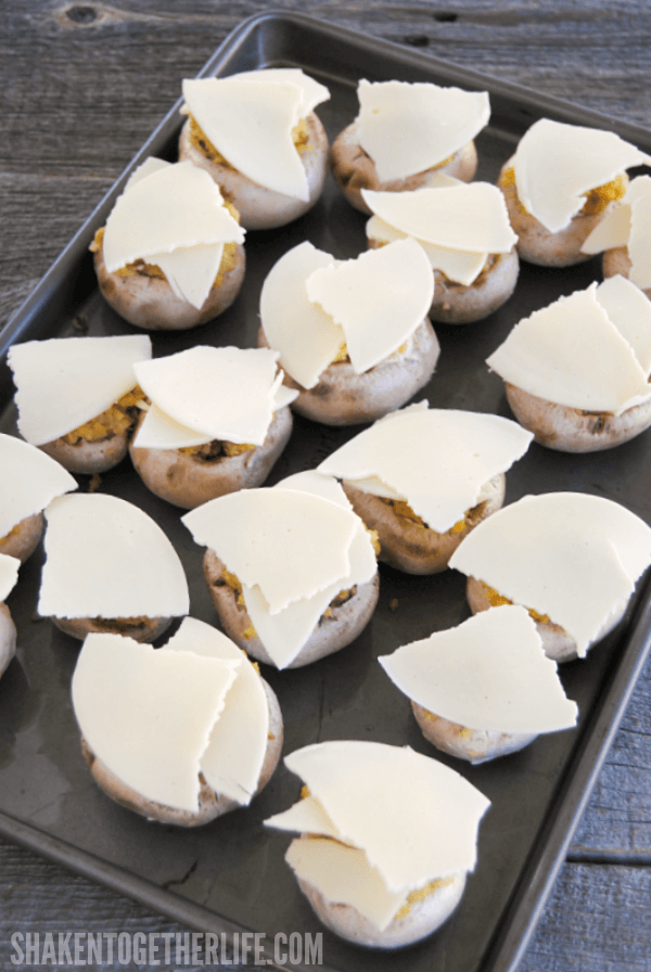 Top each stuffing stuffed mushroom with your favorite sliced cheese