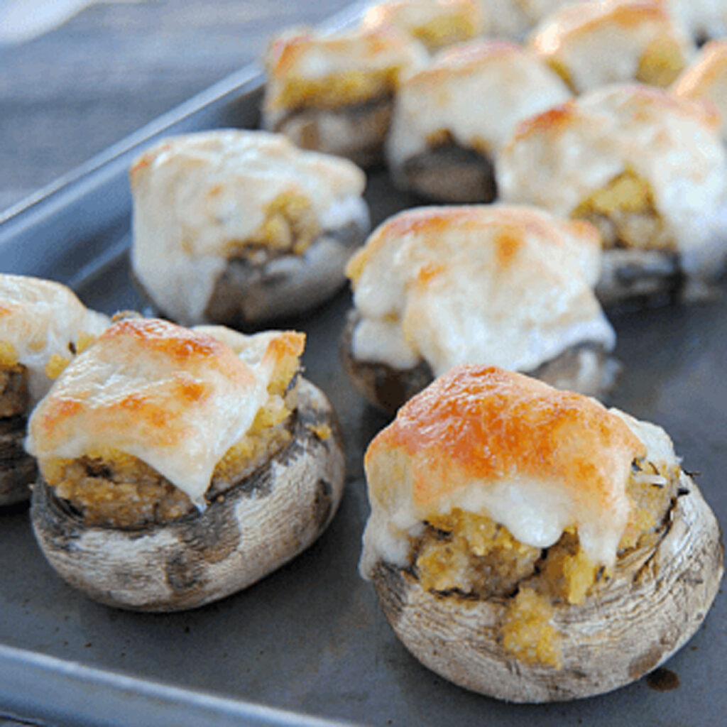 stuffing stuffed mushrooms on baking sheet