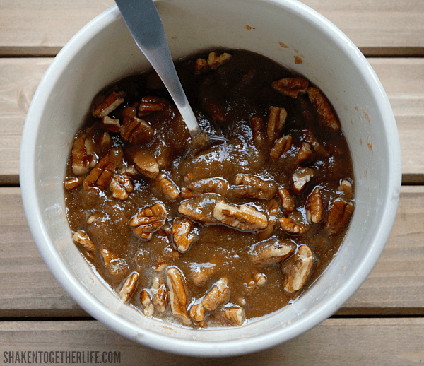 Brown sugar, butter and pecans in white bowl