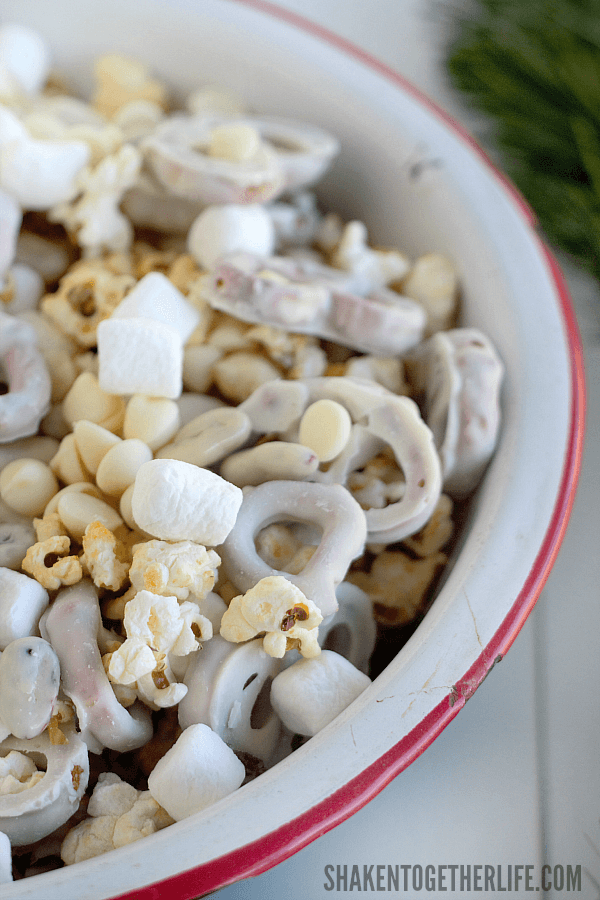 Winter Wonderland Snack Mix is the perfect sweet and salty mix of white fudge pretzels, mini marshmallows, yogurt covered cranberries, kettle corn and white chocolate chips!