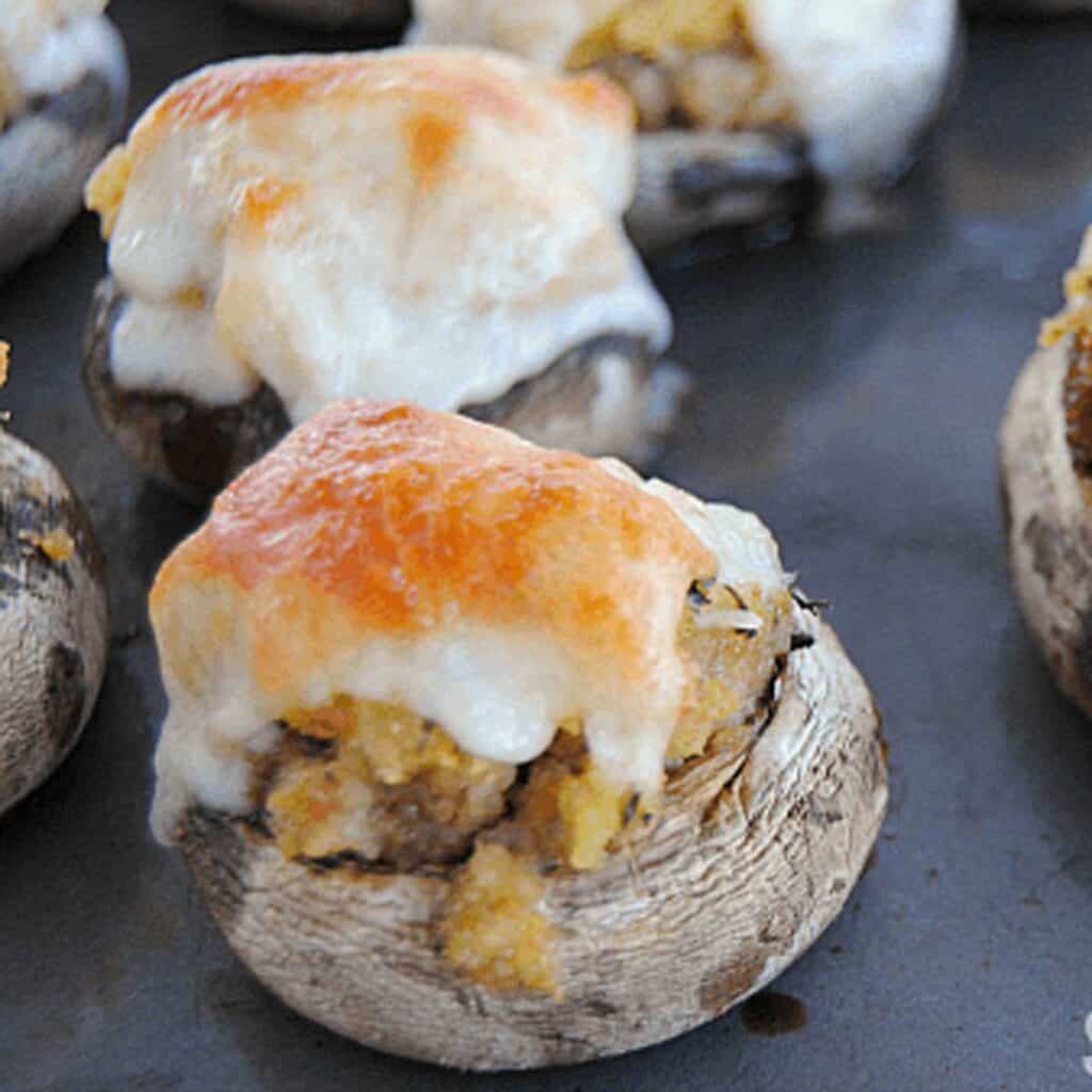 cheesy stuffed mushrooms on baking sheet
